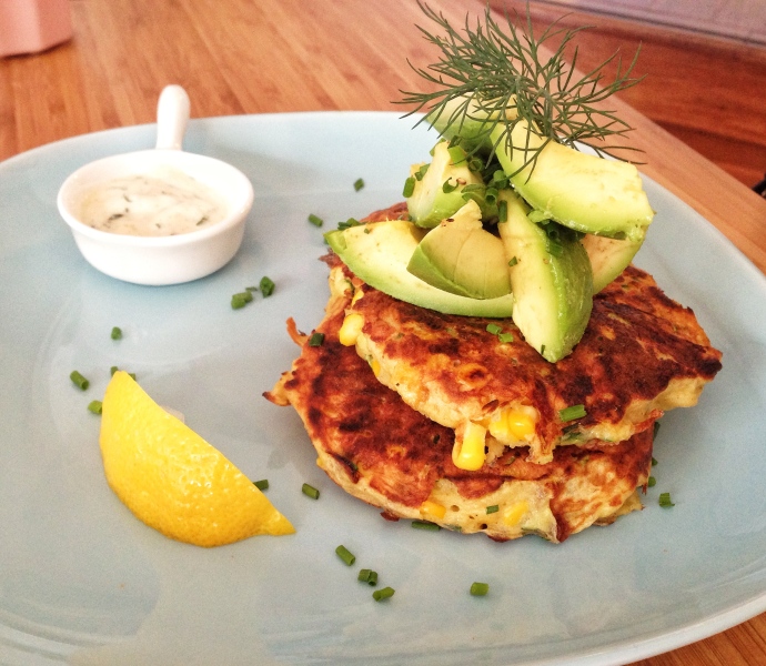 Zucchini and corn fritters with cumin yoghurt and avocado